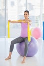 Woman sitting on exercise ball Royalty Free Stock Photo