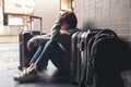 A woman sitting with feeling sad and lost while traveling