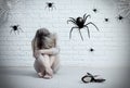 Woman sitting on the floor and looking on imaginary spider. Royalty Free Stock Photo