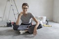 Woman sitting on the floor and planning a home renovation Royalty Free Stock Photo