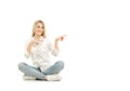 Woman sitting on floor and pointing with her finger Royalty Free Stock Photo