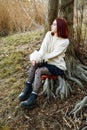 Woman sitting in forest enjoys the silence and beauty of nature. Royalty Free Stock Photo