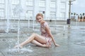 Woman is sitting in a fountain. Royalty Free Stock Photo