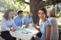 Woman sitting with friends in outdoor restaurant Royalty Free Stock Photo