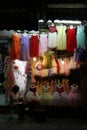 A woman is sitting in front a dress store in Hanoi (Vietnam)