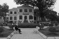 A woman is sitting in front of a library in Hanoi (Vietnam)