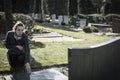 Woman sitting at grave Royalty Free Stock Photo