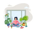 A woman is sitting at green home near the window