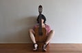 Woman sitting with a guitar