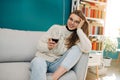 Woman sitting in her apartment holding a glass of red wine. Relaxing at home. Royalty Free Stock Photo