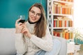 Woman sitting in her apartment holding a glass of red wine. Relaxing at home. Royalty Free Stock Photo