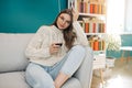 Woman sitting in her apartment holding a glass of red wine. Relaxing at home. Royalty Free Stock Photo