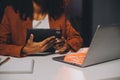 Woman sitting at her desk in home office working late at night using laptop computer; female web designer working overtime Royalty Free Stock Photo