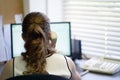 Woman sitting at her desk working and answering a phone call. Royalty Free Stock Photo