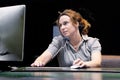 Woman sitting at her desk working and answering a phone call Royalty Free Stock Photo