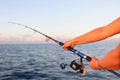 Woman sitting holding fish rod in hands Royalty Free Stock Photo