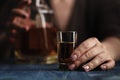 Woman sitting at home drinking way too much whiskey, she is addicted Royalty Free Stock Photo