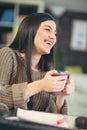 Woman sitting in home office and holding cup of coffee Royalty Free Stock Photo