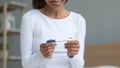 Woman sitting indoors closeup focus on hands holding pregnancy Royalty Free Stock Photo