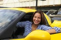 Woman sitting inside of her new sports car