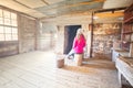 Woman sitting inside an old timber hut on log stools Snowy Mountains Royalty Free Stock Photo