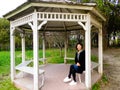 A woman sitting inside a pavilion Royalty Free Stock Photo