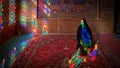 Woman sitting inside with stained glass window reflections of Nasir al-Mulk Mosque, Shiraz, Iran Royalty Free Stock Photo