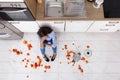 Woman Sitting On Kitchen Floor With Spilled Food Royalty Free Stock Photo
