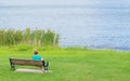 Woman sitting by a lake in Massachusetts Royalty Free Stock Photo
