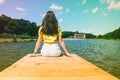 Woman sitting on a lake pier Royalty Free Stock Photo