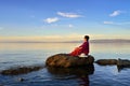 A woman sitting in the lake view