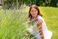 Woman on lawn near bushes of lavender. landscaping in garden, in yard.