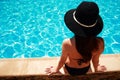 Woman sitting on the ledge of the pool Royalty Free Stock Photo