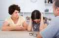 Woman sitting and looking negative while with parents