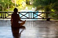 Woman sitting in lotus position with the balcony Royalty Free Stock Photo