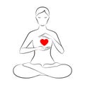 Woman is sitting in lotus position and holding hands near her heart