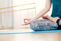 Woman sitting in lotus position idoors, hands closeup Royalty Free Stock Photo