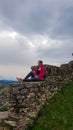 Griffen - Woman sitting on medieval stone walls. Scenic view of castle ruins Burgruine Griffen in Voelkermark Royalty Free Stock Photo