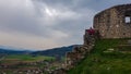 Griffen - Woman sitting on medieval stone walls. Scenic view of castle ruins Burgruine Griffen in Voelkermark Royalty Free Stock Photo