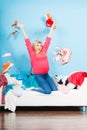 Woman sitting on messy couch throwing clothes Royalty Free Stock Photo