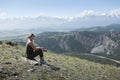 Woman Sitting On Mountain Top And Enjoying Valley View. Royalty Free Stock Photo