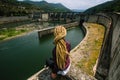 Woman sitting near an abandoned hydroelectric plant. Royalty Free Stock Photo