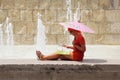 Woman sitting near fountain and looking at map Royalty Free Stock Photo