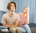 Woman sitting near her sad son and calling to doctor Royalty Free Stock Photo