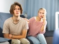 Woman sitting near her sad son and calling to doctor Royalty Free Stock Photo