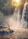 Woman sitting near waterfall enjoying the sun, Phnom Koulen at Siem Reap, Cambodia Royalty Free Stock Photo