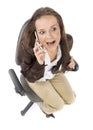 Woman sitting on the office chair - talking to the mobile phone Royalty Free Stock Photo