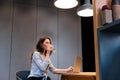 Woman sitting at office with laptop and drinking water Royalty Free Stock Photo