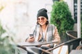 Woman sitting on open terrace in street cafe. Autumn time in cit Royalty Free Stock Photo