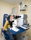 Woman sitting in optician machine Royalty Free Stock Photo